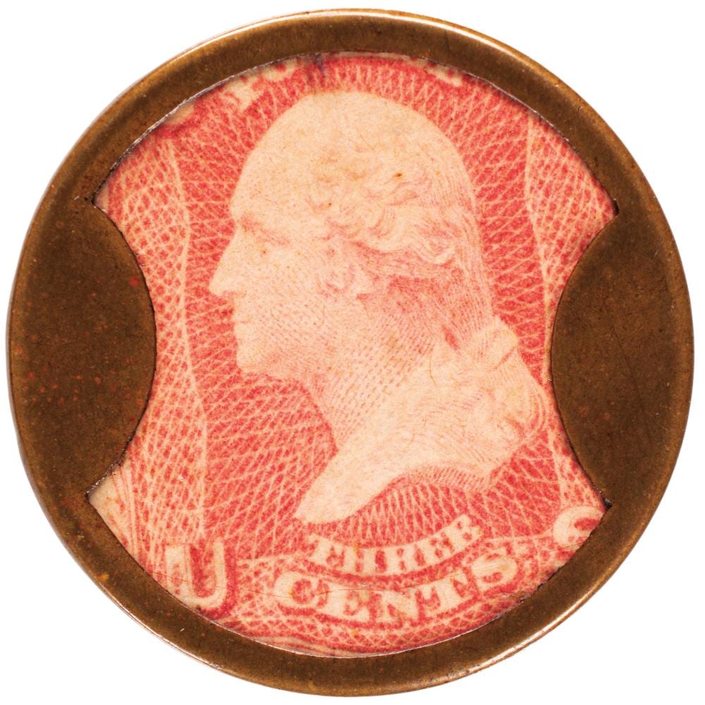 Encased red postage stamp showing a profile portrait and partial inscription in dark red, set in a dark circular metal frame.