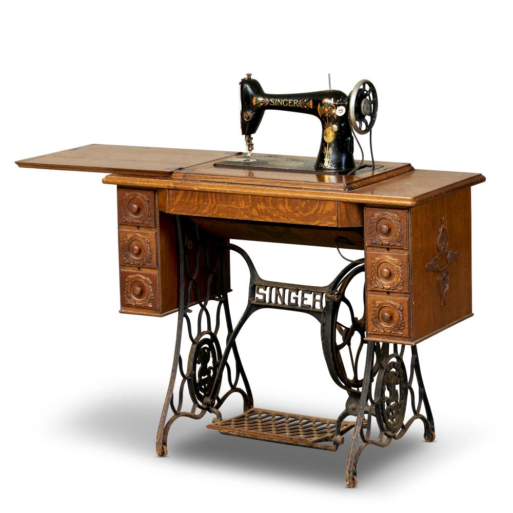 AN ANTIQUE SINGER TREADLE-OPERATED SEWING MACHINE IN OAK TABLE CASE Late 19th century sold by Leonard Joel, lot 268 — auction record photograph