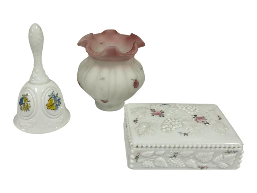 Three small white glass decorative pieces with molded shapes: two lidded boxes and a bell-shaped container with painted floral details.