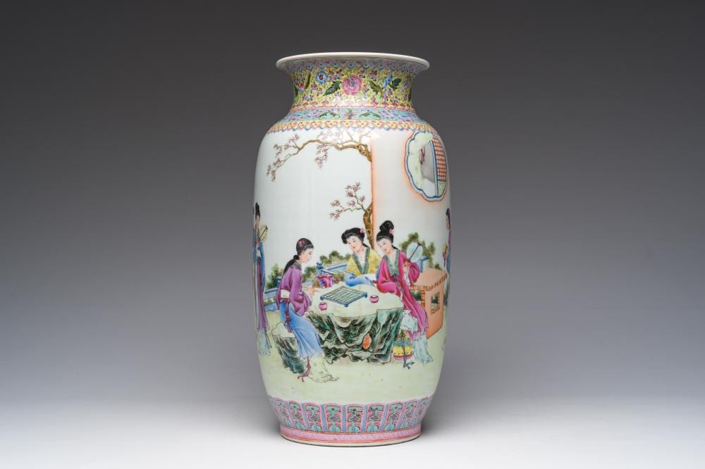 Porcelain Chinese-style vase with a flared rim, painted with court ladies relaxing at a table in a garden on a white ground.