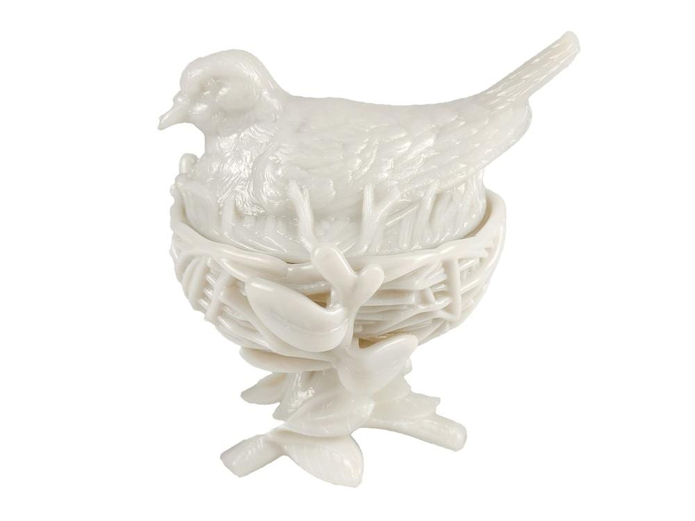 White milk glass covered dish shaped like a bird standing on a decorative base with raised basketweave details.