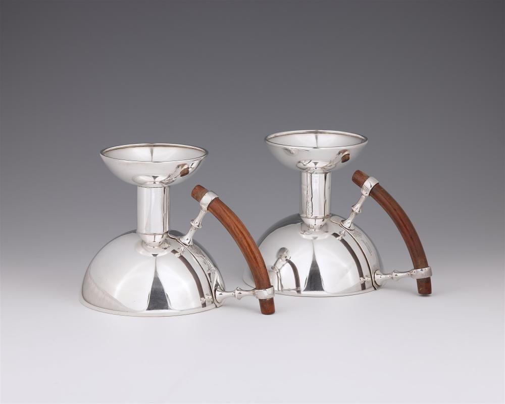 Christopher Dresser comparable auction result: a pair of kordofan silver plated chambersticks by christopher dresser