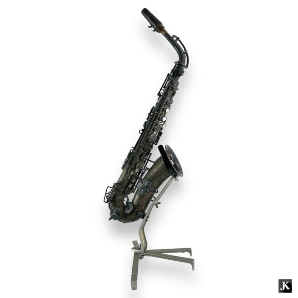 Vintage black saxophone with silver-colored keys resting on a stand against a white background.