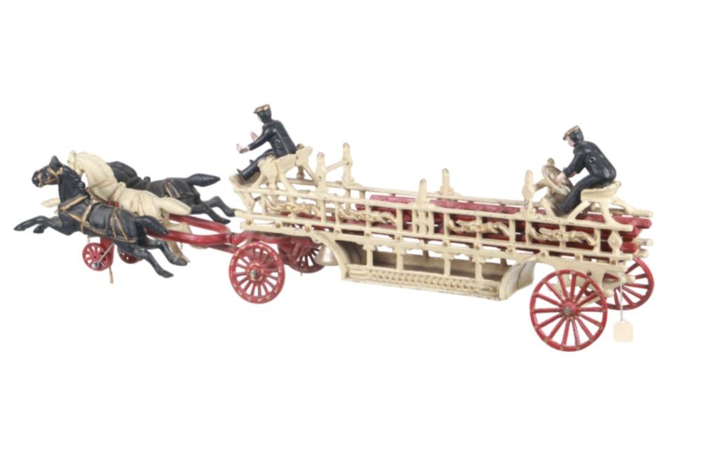 Vintage toy hook-and-ladder fire truck with two horses, black drivers, red wheels, and a beige ladder on wheels.