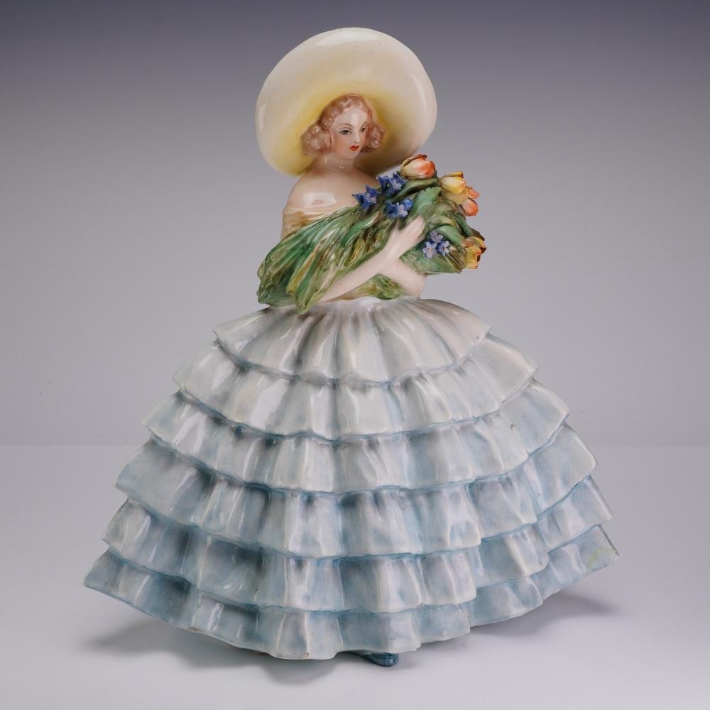 Guido Cacciapuoti comparable auction result: guido cacciapuoti italy 1892 1953 porcelain figurine of a lady in a large dress holding flowers