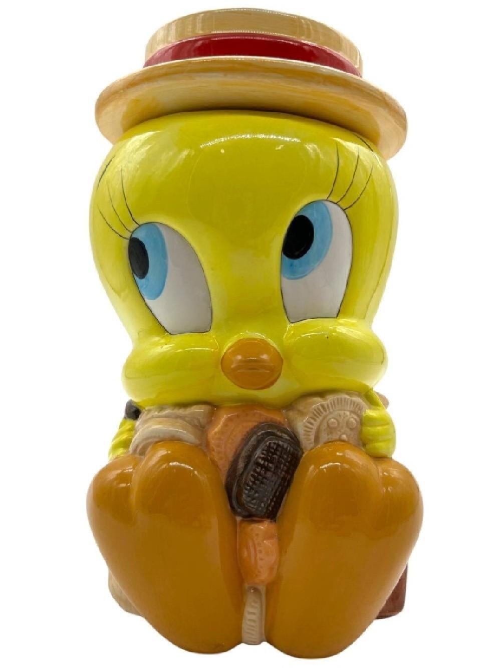 Yellow Tweety Bird ceramic cookie jar with red cap and molded facial details.