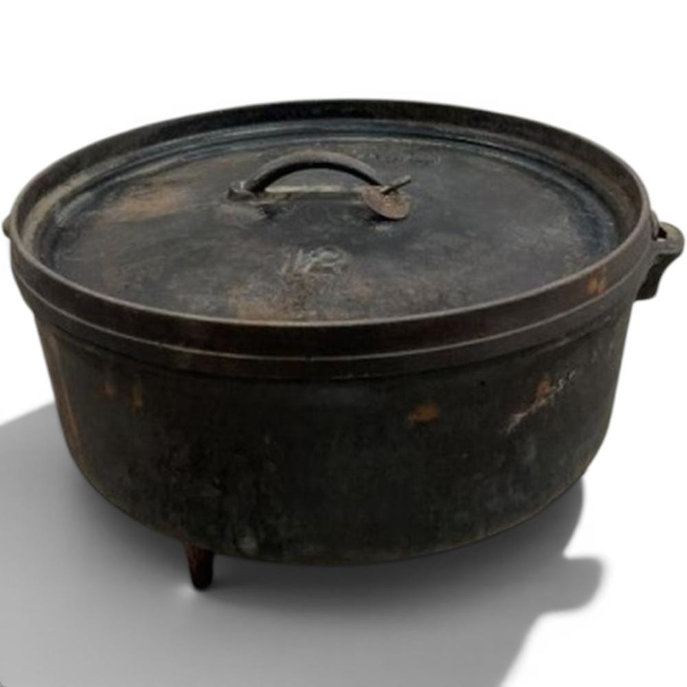 Cast iron camp Dutch oven with a flat lid and bail handle, shown in close-up on a white background.