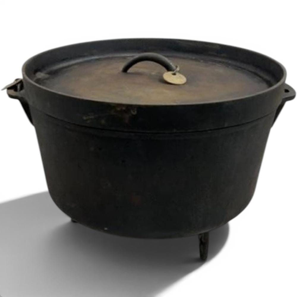Cast iron Dutch oven with lid and loop handle on a white background.
