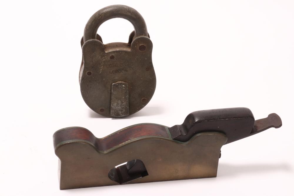 Large metal padlock with a curved shackle, shown with another padlock component on a white background.
