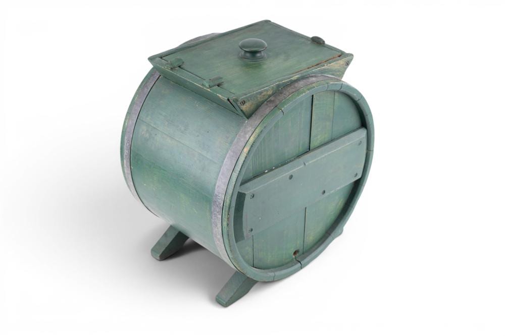 Light blue wooden butter churn with a domed lid and hinged front panel, shown from a three-quarter view.