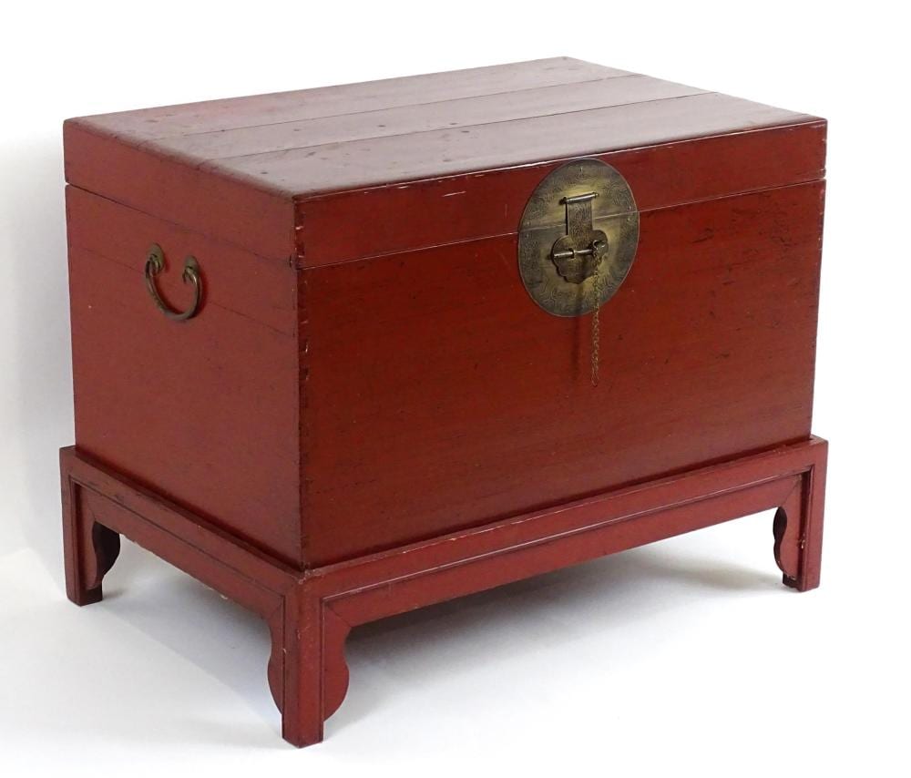 Carl Frederik Reuterswärd comparable auction result: an early 20thc oriental trunk on stand with a brass lock and flanked by car