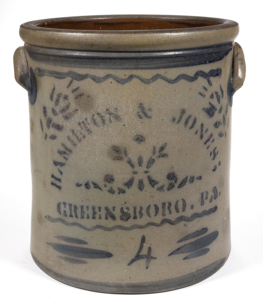 Stoneware crock with dark blue stenciled decoration and small side handles, shown against a white background.