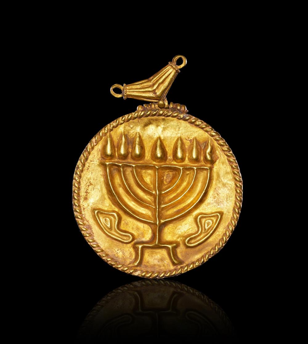 AN EARLY JEWISH GOLD MENORAH AMULET,LATE ROMAN TO BYZANTINE PERIOD, CIRCA 4TH-5TH CENTURY A.D. sold by PLAKAS, lot 36 — auction record photograph