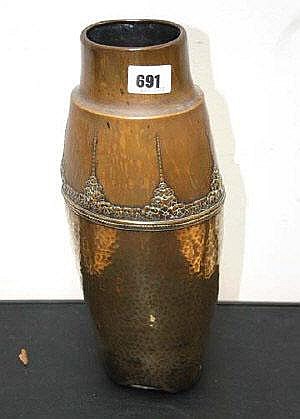 Hammered brass vase with a wide rounded body and flared rim, standing on a dark surface.