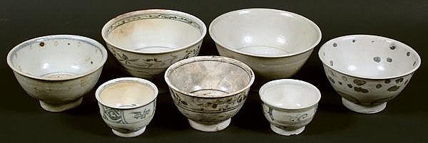SEVEN HOI AN HOARD CERAMIC BOWLS. 7 blue and white glazed ceramic bowls with raised foot. (1) plain with interior thin band and stylized symbol at center, Butterfields auction number 115849, 3 1/2''H, 6 3/8''diam. rim, 2 3/4''diam. base, minor sold by Dargate Auction Galleries, lot 2413 — auction record photograph