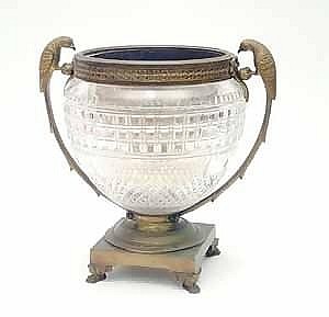 A Victorian gilt bronze mounted cut-glass bowl by F & C Osler, the bowl cut with bevelled squares and hob nail decoration with guilloche decorated rim with parrot side handles on square base with winged paw feet, stamped under base, 11.5ins F & C sold by Gorringes, lot 350 — auction record photograph