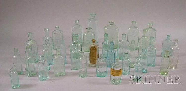 Thirty-five Aqua Mostly Embossed Pontiled Glass Medicine and Ink Bottles, including Dr. Wistar's, two Dr. D. Jayne's, two Phoenix Bit sold by Skinner, lot 874 — auction record photograph