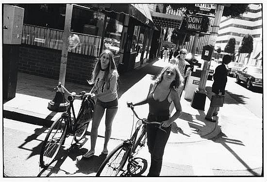 WINOGRAND, GARRY (1928-1984) Untitled (two women with bikes). sold by Swann Auction Galleries, lot 226 — auction record photograph