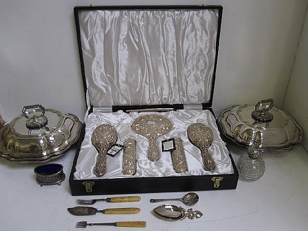 A cased silver mounted six piece dressing table set, Broadway & Co, Birmingham 1975, heavily embossed in late Victorian style, George V embossed silver mounted spherical cut glass perfume bottle, Edwardian navette shape silver salt cellar, in sold by Bonhams, lot 477 — auction record photograph