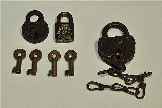 Photo showing several small padlocks and four matching keys, including a U.P.R.R. signal padlock with a brass key on a white background.