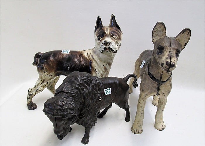 CAST IRON COIN BANK AND TWO DOOR STOPS: (1) sold by O'Gallerie, lot 338 — auction record photograph