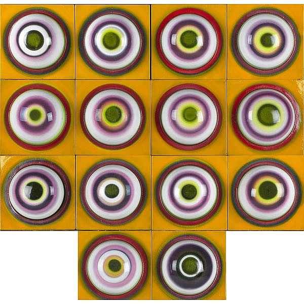 Grid of colorful circular enamel-like designs with green centers on a yellow background.