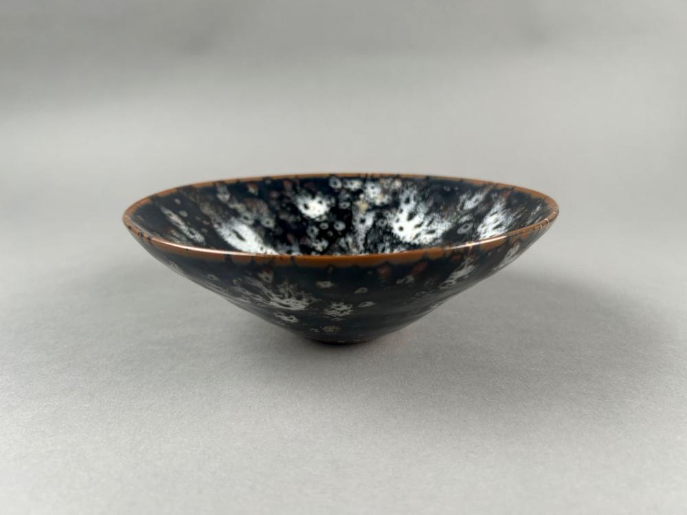 Porcelain dinnerware bowl with hand-painted markings and tableware details