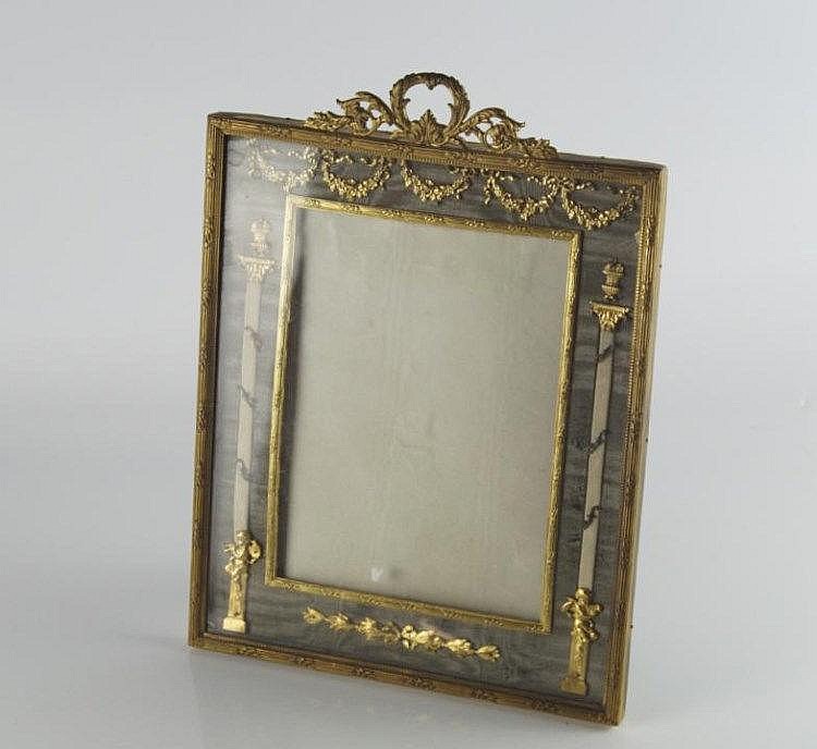 Ornate rectangular gilt picture frame with carved floral scrollwork and an empty inner backing