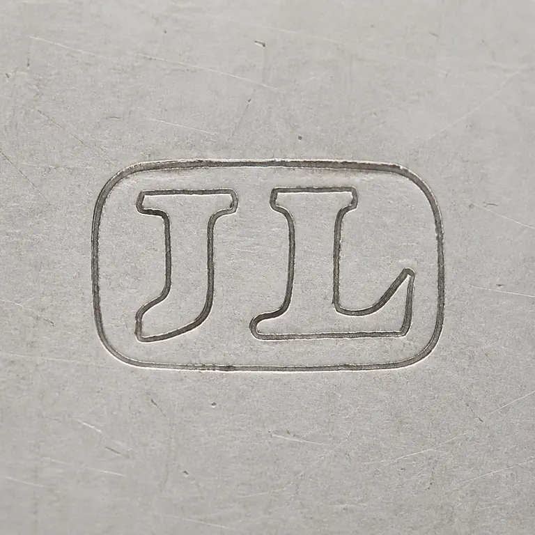 Joseph Law: JL as two uppercase serif capitals without punctuation, tightly spaced inside one compact horizontal oval or rounded cartouche; oxidized reconstruction.