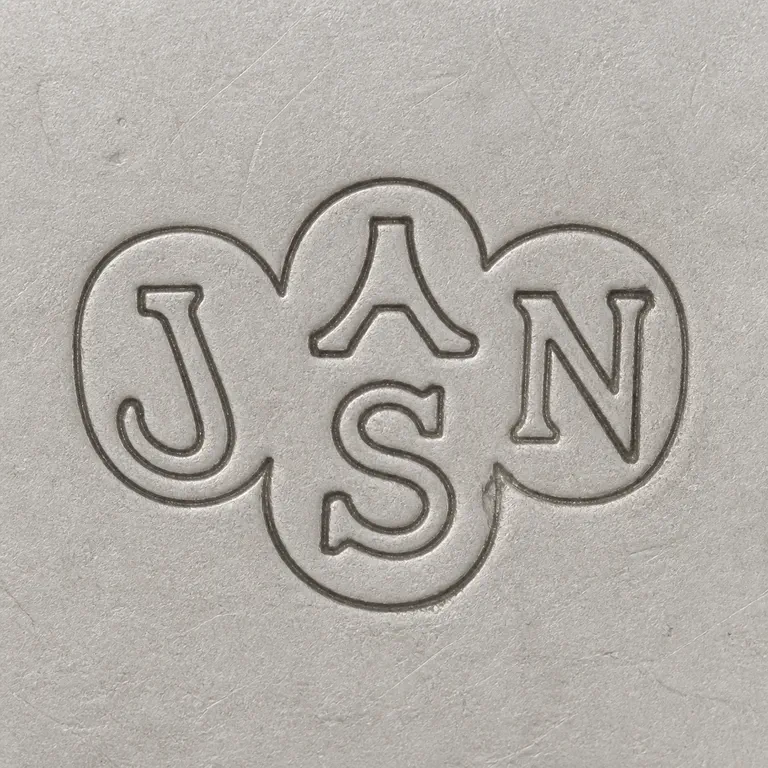 Junior Army & Navy Stores: A three-lobed rounded punch with J, A-like, N, and lower S-like forms is reconstructed adjacent lobe arrangement; oxidized reconstruction.