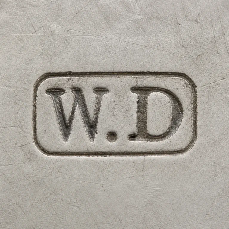 William Dudley (possibly): A rounded rectangular W.D punch is reconstructed border, orientation, and supported W and D forms; oxidized reconstruction.