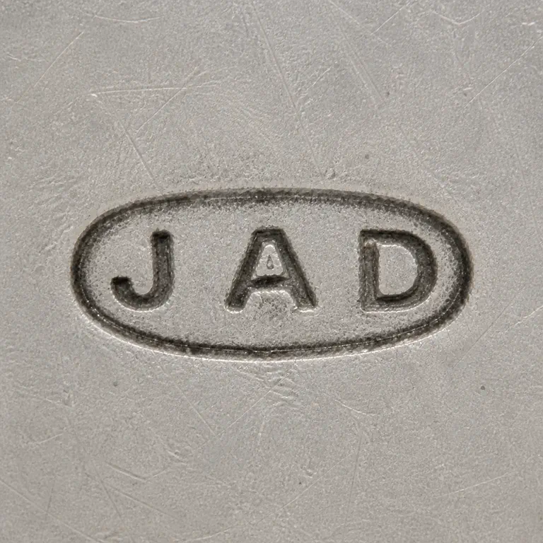 J A D: J A D arranged left to right inside one horizontal oval cartouche; oxidized reconstruction.