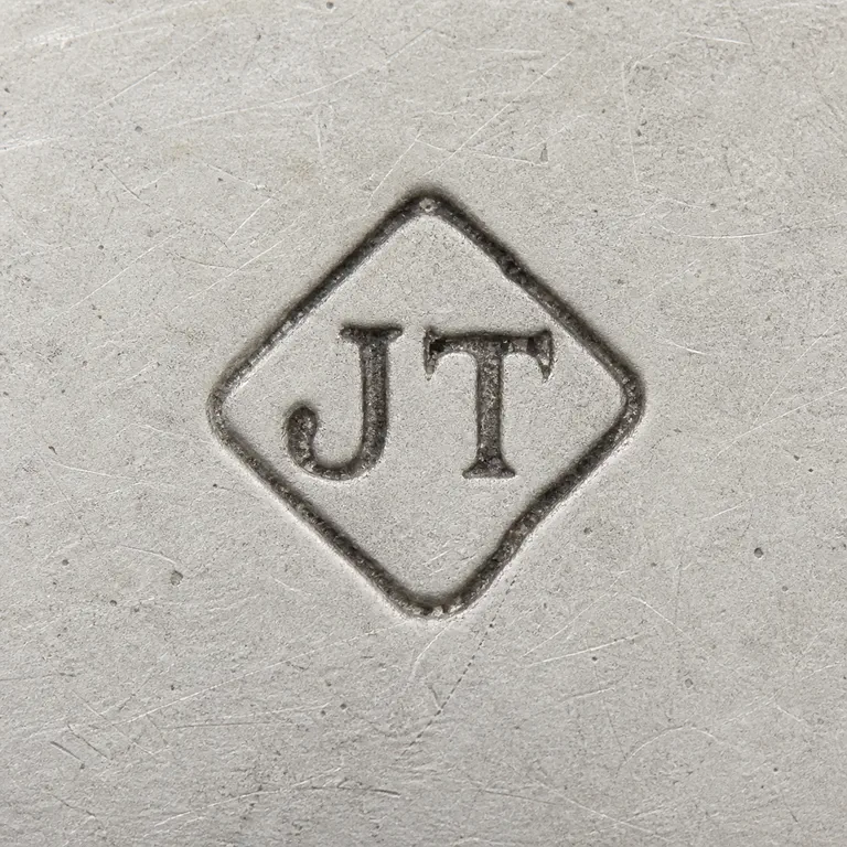 Joanna Lesley Thomson: J T arranged within one compact diamond-shaped cartouche; oxidized reconstruction.