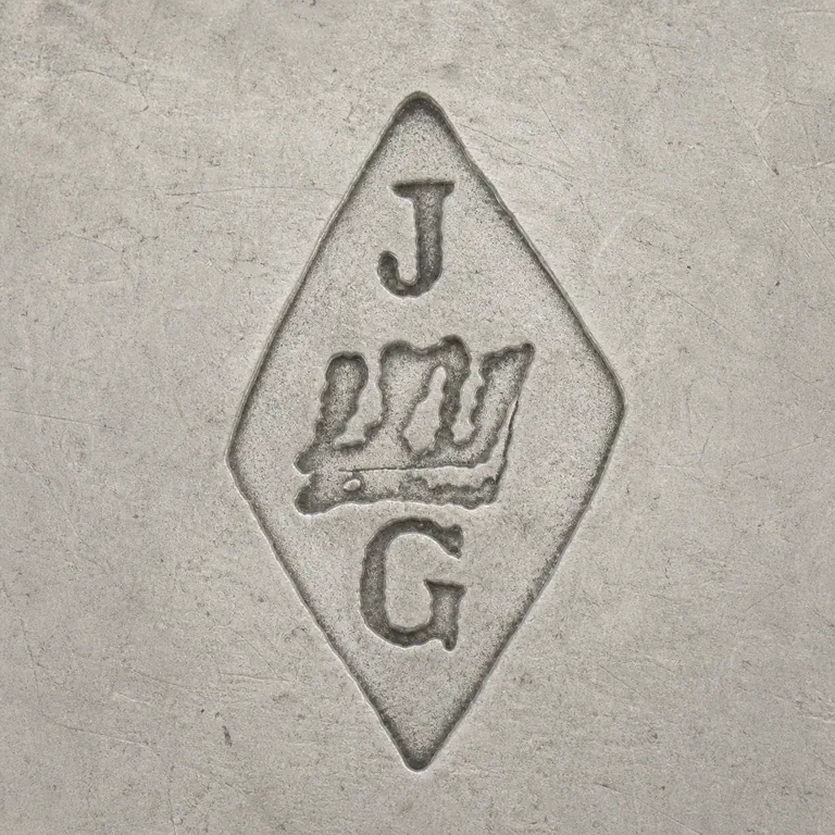 Joseph Antoine: Vertical diamond punch with J above, G below, and one worn three-lobed central line device; oxidized reconstruction.