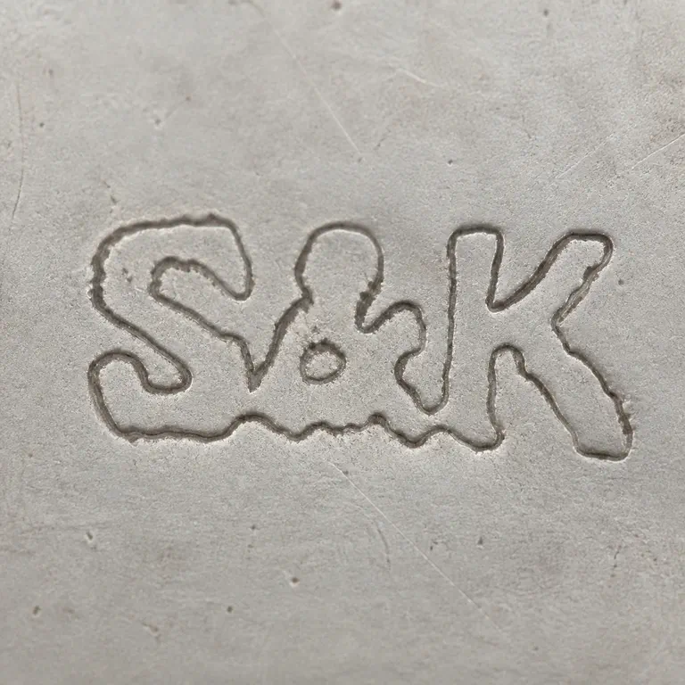 Slade & Kempton: S-like, ampersand-like, and K-like forms are retained left to right connected irregular worn group; oxidized reconstruction.