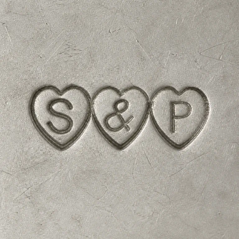 Simmons & Paye: Three separate adjacent heart punches containing uppercase S, ampersand, and uppercase P in left-to-right order; oxidized reconstruction.