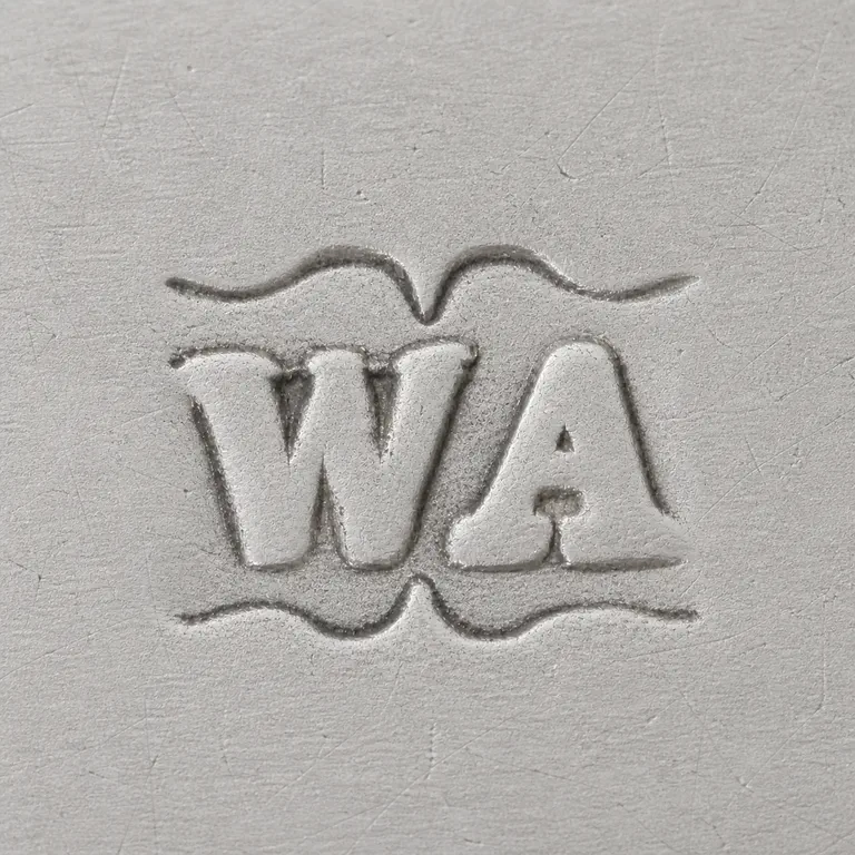 W A: Source-linked W/A-like two-form group and visible ornamental upper and lower boundary shapes retained clean white field; oxidized reconstruction.