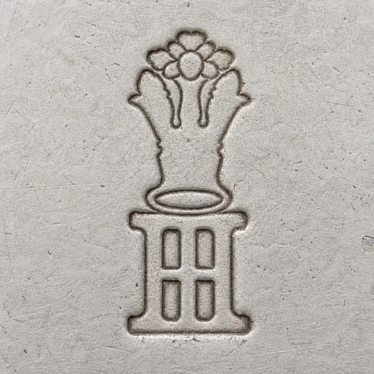 John Hopkins: Square contour reconstruction preserves the tall floral or rosette-like upper ornament, layered central structure, lower I/H-like forms,…; oxidized reconstruction.
