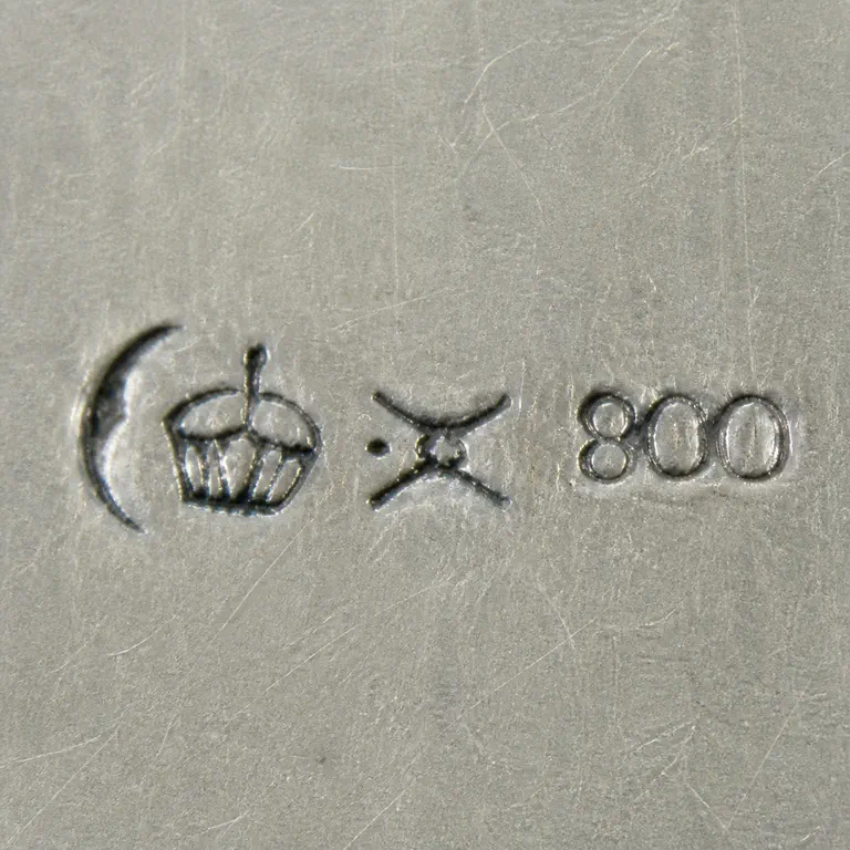 looking for info: Crescent, crowned cluster, crossed hammer-like device, and exact 800 left to right; oxidized reconstruction.