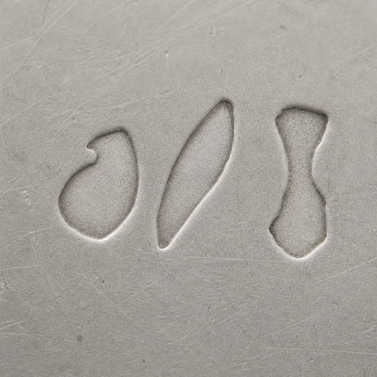 Richard Köberlin: Three isolated worn shapes without lettering; oxidized reconstruction.