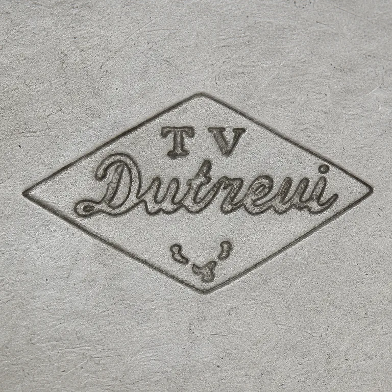 Tallois & Mayence: Horizontal diamond with small T V at top, cursive Dutrevi across the middle, and three tiny disconnected lower curls; oxidized reconstruction.