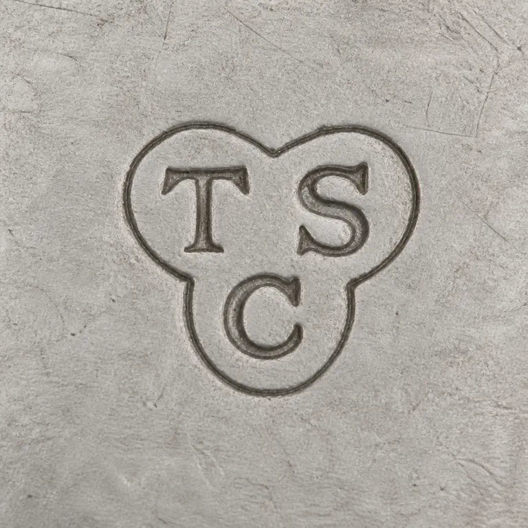 T. S. C. (presently unknown): Uppercase T and S on the upper tier with uppercase C centered below, arranged TS / C inside one compact three-lobed clover-like enclosure; oxidized reconstruction.