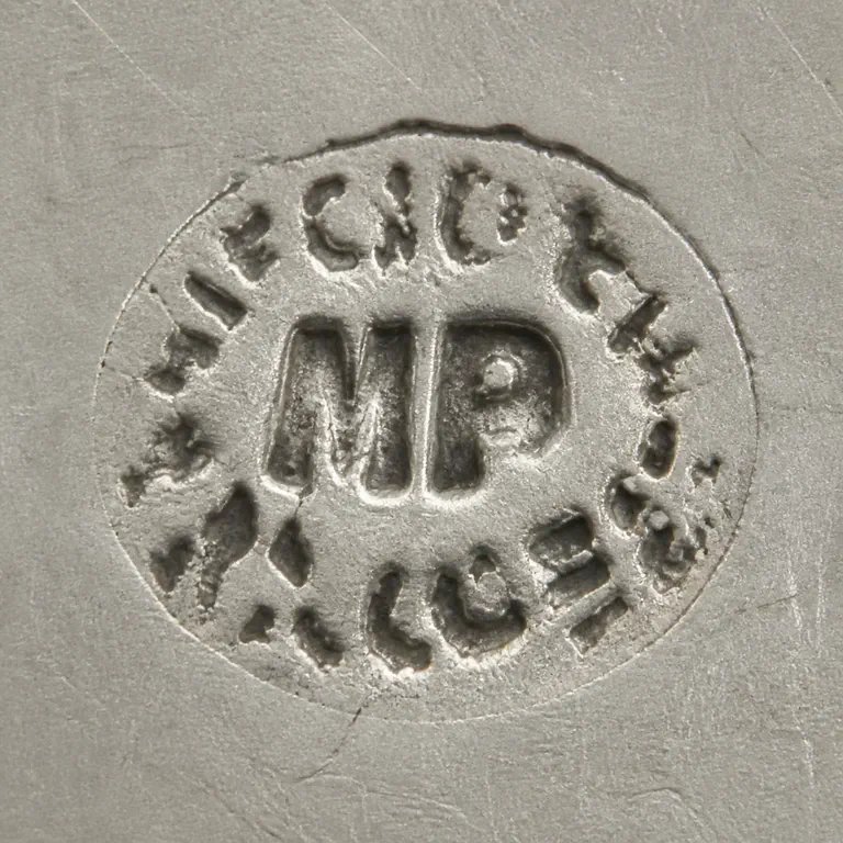 Miguel Alonzo: One irregular closed perimeter contains a central MP-like monogram and disconnected peripheral wear fragments without a completed word; oxidized reconstruction.