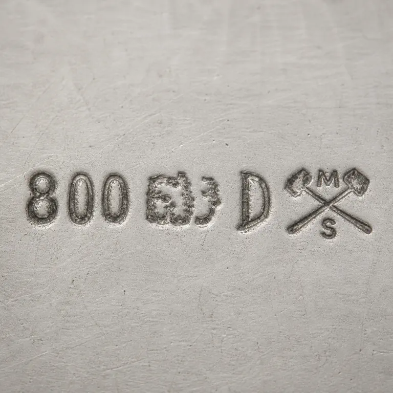 Robert Altermann: The digits 800, two worn linked middle fragments, crossed bars or hammers, and M above S in order; oxidized reconstruction.