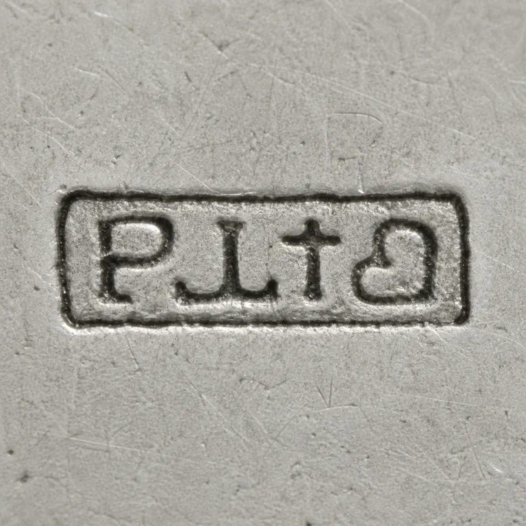 Prestons Ltd: P, L, t-like, and d-like forms arranged left to right inside one compact worn rectangular cartouche; oxidized reconstruction.