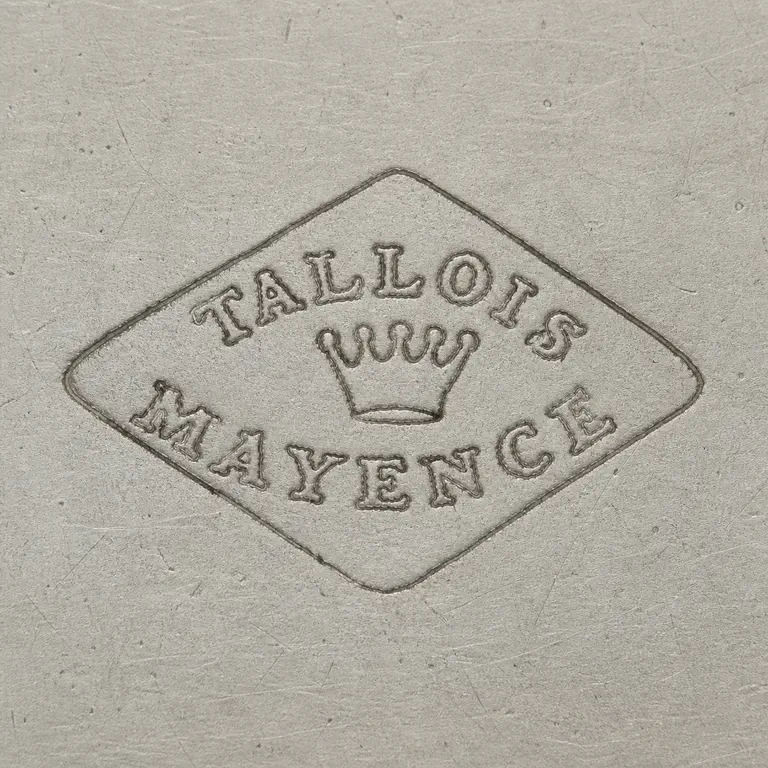 Tallois & Mayence: Horizontal diamond with TALLOIS on the upper arc, a small five-point crown-like center device, and MAYENCE on the lower arc; oxidized reconstruction.