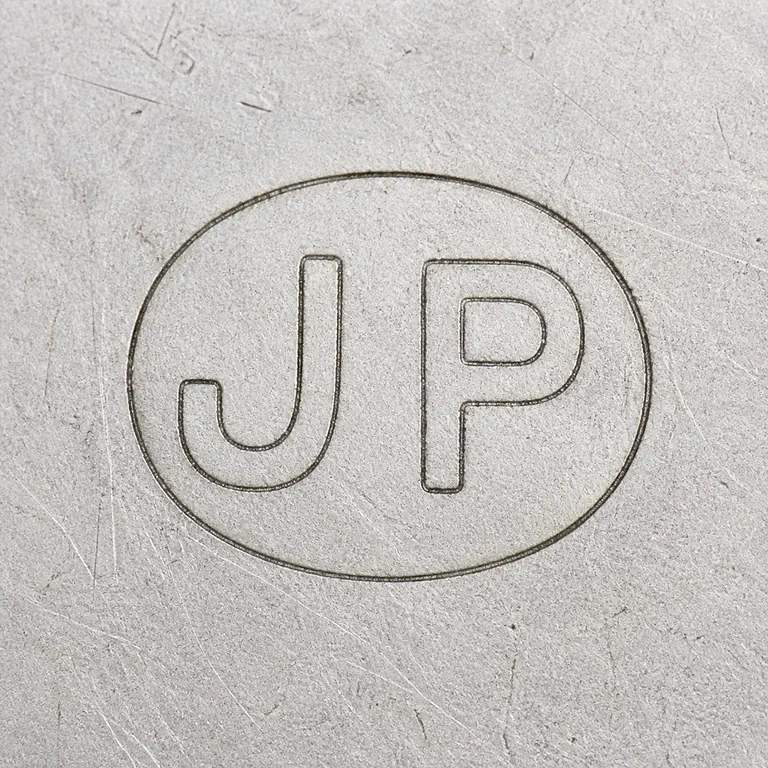 John Pinches Ltd: Square contour reconstruction preserves the single oval frame and supported J/P-like forms with order, spacing, proportions, and orientation; oxidized reconstruction.