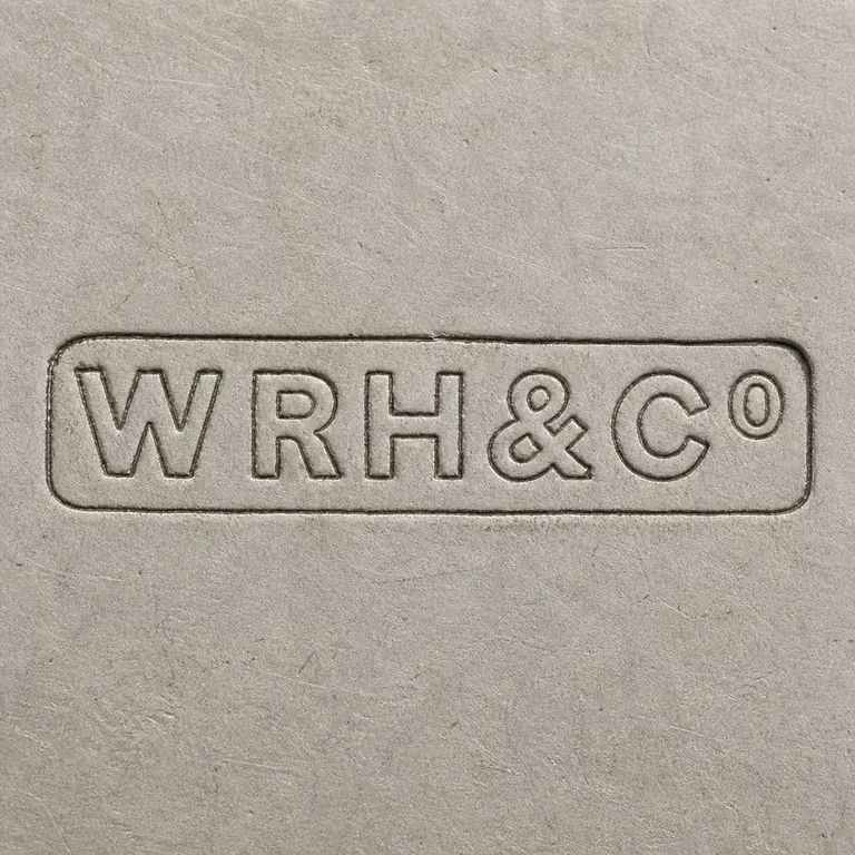 W. R. Humphreys & Co.: WRH&Co as uppercase W, R, H, one ampersand, uppercase C, and one small raised lowercase o on one line inside one long narrow rounded-rect…; oxidized reconstruction.