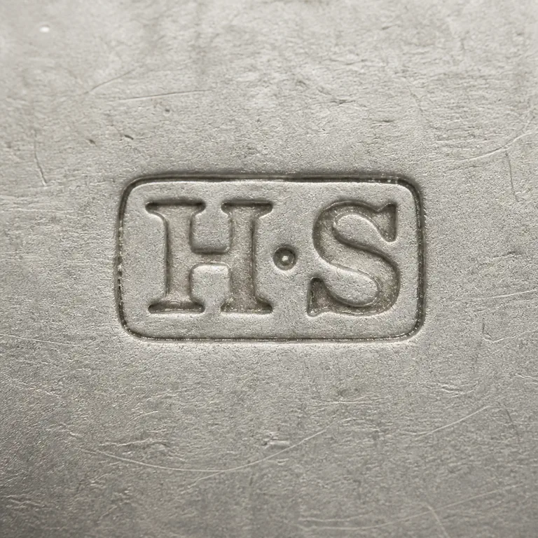 Henry Stratford: H•S as two worn uppercase serif capitals with one centered dot between them, inside one compact horizontal rounded-rectangle cartouche; p…; oxidized reconstruction.