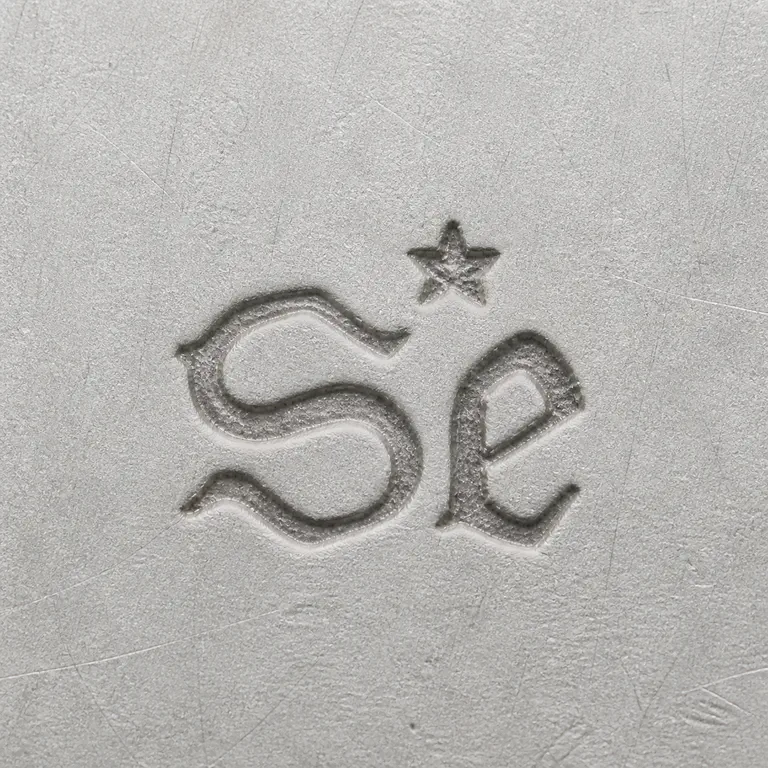James Seabrook: A large worn S-like glyph, adjacent compact looped glyph, and one small star-like mark above are retained; the corrected master omits an…; oxidized reconstruction.